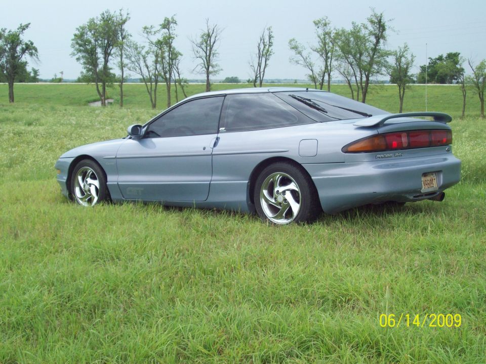 pic of left side of car with the chrome swirley rims