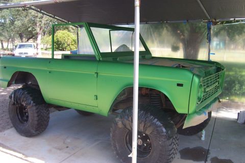 1976 Ford Bronco - This 1976 Ford Bronco is undergoing a paint job, with its large tires covered for protection.