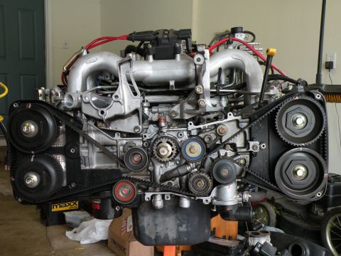 1998 Subaru Legacy - Close-up view of a disassembled Subaru engine, showing the intricate timing belt system.