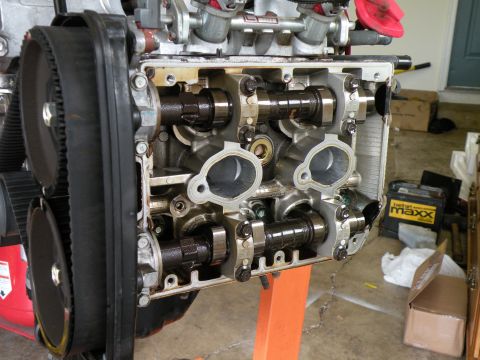 1998 Subaru Legacy - Close-up of an engine's internal components, including camshafts and timing belt, with the cylinder head off.