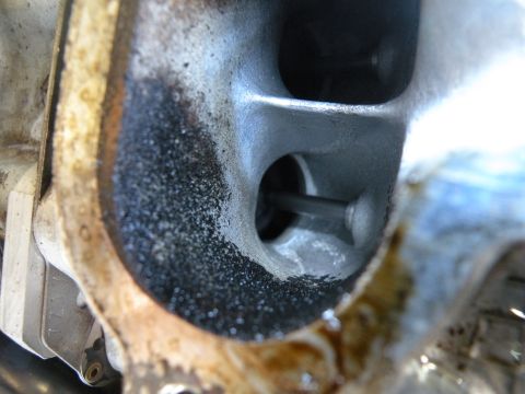 1998 Subaru Legacy - This image shows the inside of an engine's intake port, highlighting carbon deposits and a valve stem.