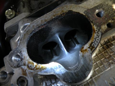 1998 Subaru Legacy - Close-up view of an engine's cylinder head, showing the intake or exhaust ports and valves.