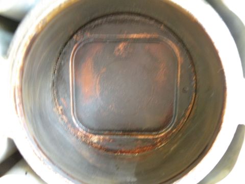 1998 Subaru Legacy - Close-up view of an engine cylinder interior, showing significant carbon deposits and wear.