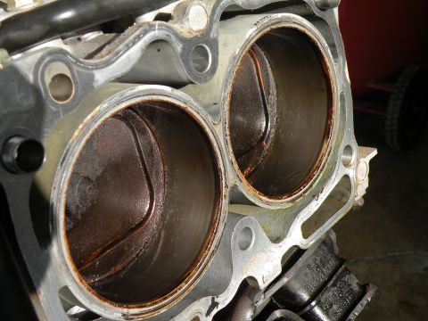 1998 Subaru Legacy - Close-up view of engine cylinders with visible wear and residue.