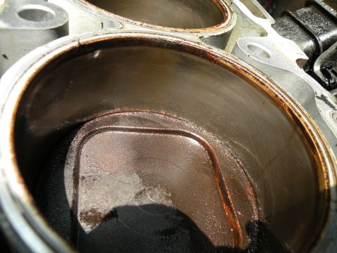 1998 Subaru Legacy - Close-up view of engine cylinders showing oil residue and wear marks.