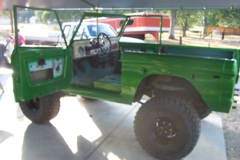 1976 Ford Bronco - This 1976 Ford Bronco is shown with its doors open, indicating it is likely in a state of restoration or repair.