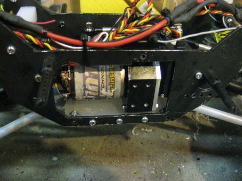 2010 Ford Pickup - Close-up view of an RC car chassis, showing the motor and electrical wiring within the black frame.
