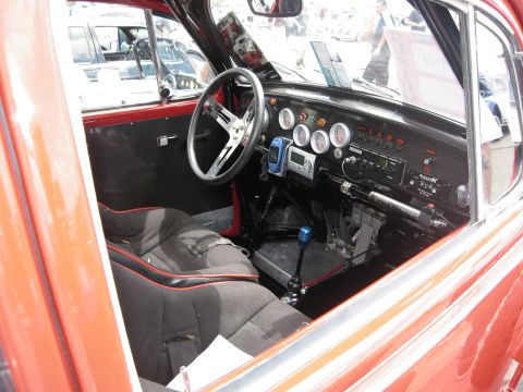 1986 Ford Bronco - Customized interior features racing seats, a unique steering wheel, and an array of gauges on the dashboard.