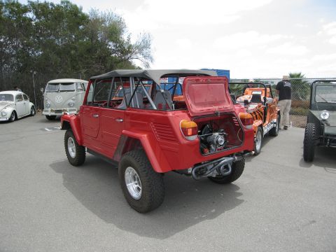 1986 Ford Bronco - Several Volkswagen vehicles, including a red Thing and a VW bus, parked outdoors.