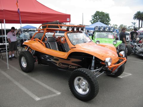 1986 Ford Bronco - Orange "Desert-Craft" dune buggy at an outdoor event with other vehicles present.