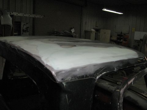 1966 Ford F-100 - Body filler is applied to the roof of a truck undergoing repairs in a workshop.