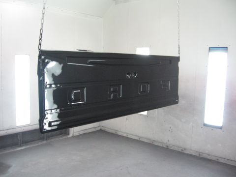 1966 Ford F-100 - Newly painted Ford tailgate suspended in a paint booth for drying.