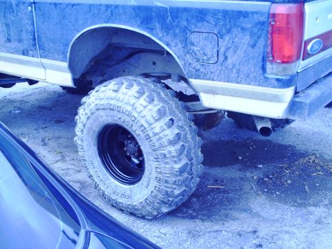 1990 Ford Bronco - This lifted Ford Bronco features aggressive off-road tires and a two-tone paint scheme.