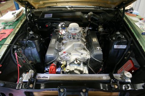 1971 Ford Ranchero - Custom V8 engine installed in a vehicle's engine bay, aftermarket components and a large carburetor.