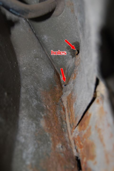 1985 Mercury Grand Marquis - Close-up view of rusted metal showing holes, with red arrows indicating the damage.
