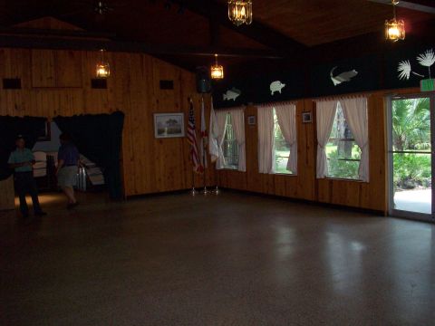 1985 Ford Bronco - Room interior with wood paneling, windows showing greenery, and flags displayed.