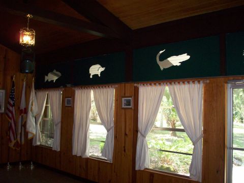 1985 Ford Bronco - The room features decorative cutouts of animals above the windows, with flags displayed on the left side.