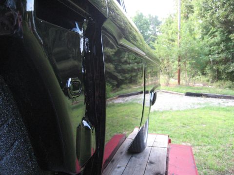 1966 Ford F-100 - Side view of a freshly painted 1966 Ford F-100 pickup truck.