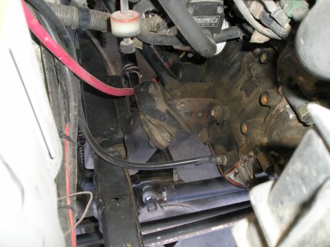 1986 Toyota Hilux - A close-up view of various engine components, including hoses and wiring, within a vehicle's engine bay.