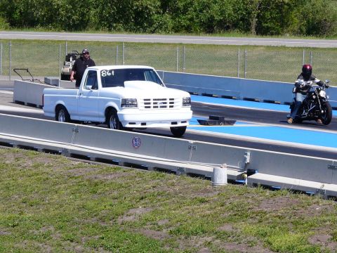1994 Ford F-150 - White 1994 Ford F-150 drag truck and a motorcycle race on a drag strip.