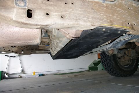 1995 Ford Bronco - Underside view of a vehicle's frame, highlighting a skid plate and suspension components.
