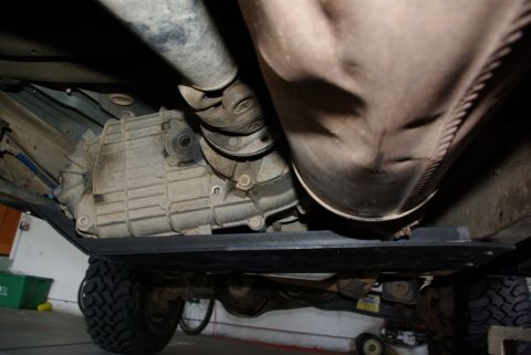 1995 Ford Bronco - This image shows the transfer case and exhaust system of a vehicle, protected by a skid plate. The registry claims it is a 1995 Ford Bronco…