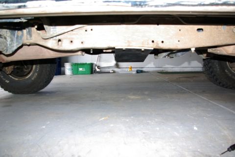 1995 Ford Bronco - Underside view of a vehicle's frame and suspension components, including a skid plate.