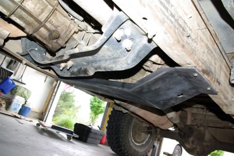 1995 Ford Bronco - Underside view of a 1995 Ford Bronco showing the transfer case skid plate and exhaust system.