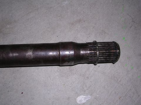 1983 Ferrari Enzo - A close-up view of a metal driveshaft component with visible splines and a ring.