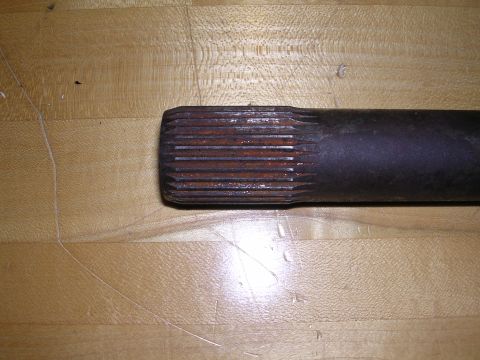 1983 Ferrari Enzo - A splined shaft part is shown resting on a wooden surface.