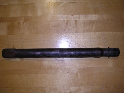 1983 Ferrari Enzo - A single driveshaft is shown against a wooden background, with splined ends for connection.