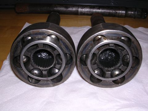 1983 Ferrari Enzo - Close-up of two CV joints and a driveshaft, likely for a vehicle's drivetrain.