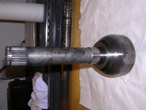 1983 Ferrari Enzo - A close-up view of a CV axle shaft, a critical component for vehicle drivetrain systems.