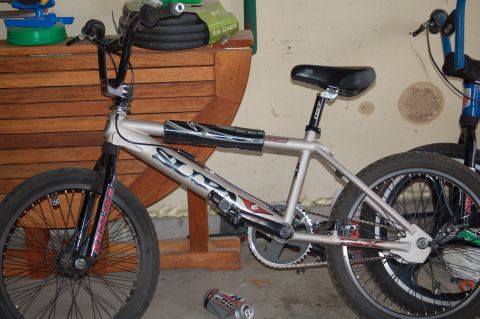 1991 Ford Escort - A silver bicycle is shown from the side, with another bicycle partially visible behind it.
