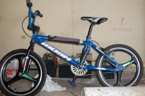 1991 Ford Escort - A blue Mongoose BMX bicycle is shown in a side view, black mag wheels and silver detailing on the frame.