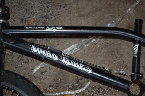 1991 Ford Escort - Close-up of a black Haro Bikes BMX frame, showing the 'Backtrail XE' model name.