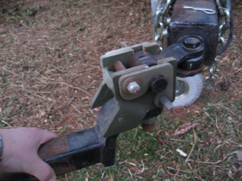 1996 Ford Bronco - Close-up of a trailer hitch assembly, showing the ball mount and safety chains.