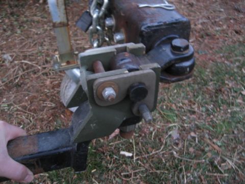 1996 Ford Bronco - Close-up of a trailer hitch mechanism, showing the ball coupler and locking pin assembly.