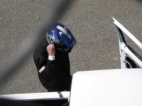 1994 Ford F-150 - Person in racing gear adjusts helmet near an open vehicle door. Supermotors.net logo is present.