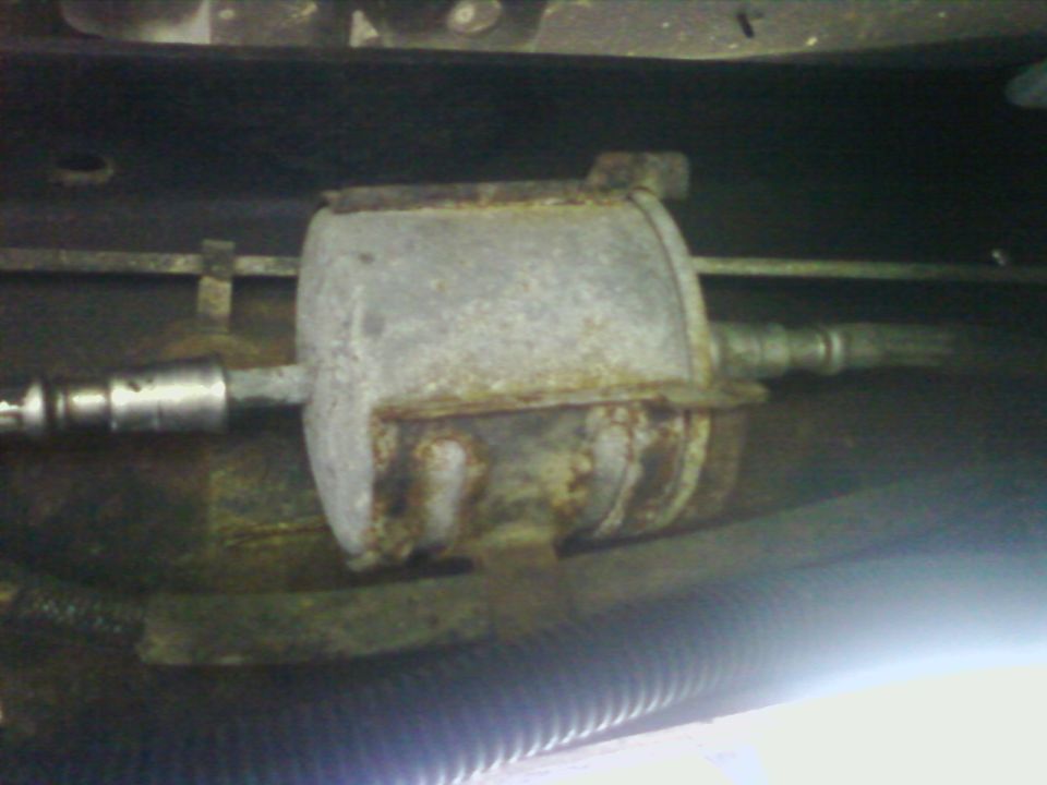 Rusted fuel filter mounted underneath a vehicle