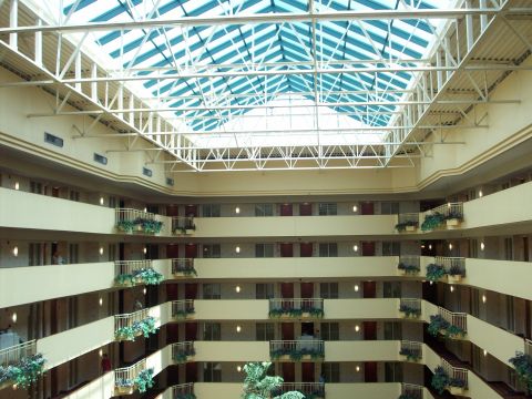 1985 Ford Bronco - Interior view of a hotel atrium with balconies on multiple levels and a large glass ceiling.