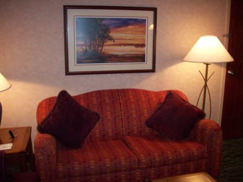 1985 Ford Bronco - A hotel room scene a sofa, artwork, and a lamp.
