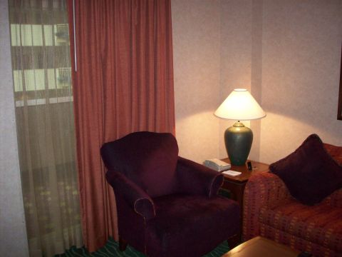 1985 Ford Bronco - Interior view of a hotel room with furniture and window coverings.