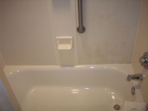 1985 Ford Bronco - Interior view of a bathtub with a grab bar and soap dish.