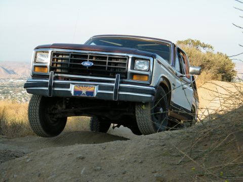 1982 Ford Bronco - Ford Bronco navigates a dirt path on a hillside.