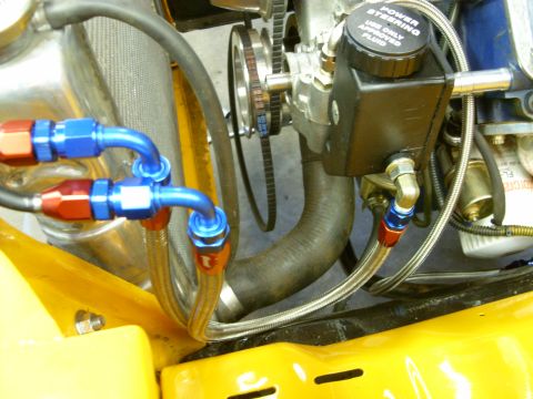 1978 Ford Mustang II - Close-up of engine bay components, including a power steering reservoir and braided fluid lines.