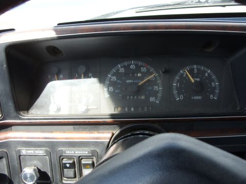 1988 Ford Bronco - The dashboard of a vehicle shows the speedometer, tachometer, and other gauges. The odometer reads 30,258 miles.