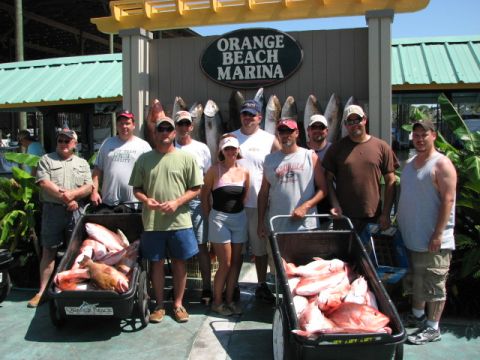 1979 Ford F-150 - A group of anglers poses with their impressive haul of fish in front of the Orange Beach Marina.