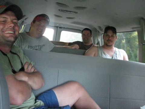 1979 Ford F-150 - Four men are riding in the back of a van, with one man in the foreground smiling.