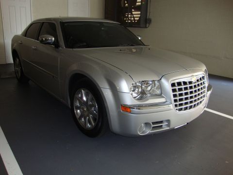 2008 Chrysler 300 - A silver Chrysler 300 sedan is parked in a garage, showing its front quarter view.